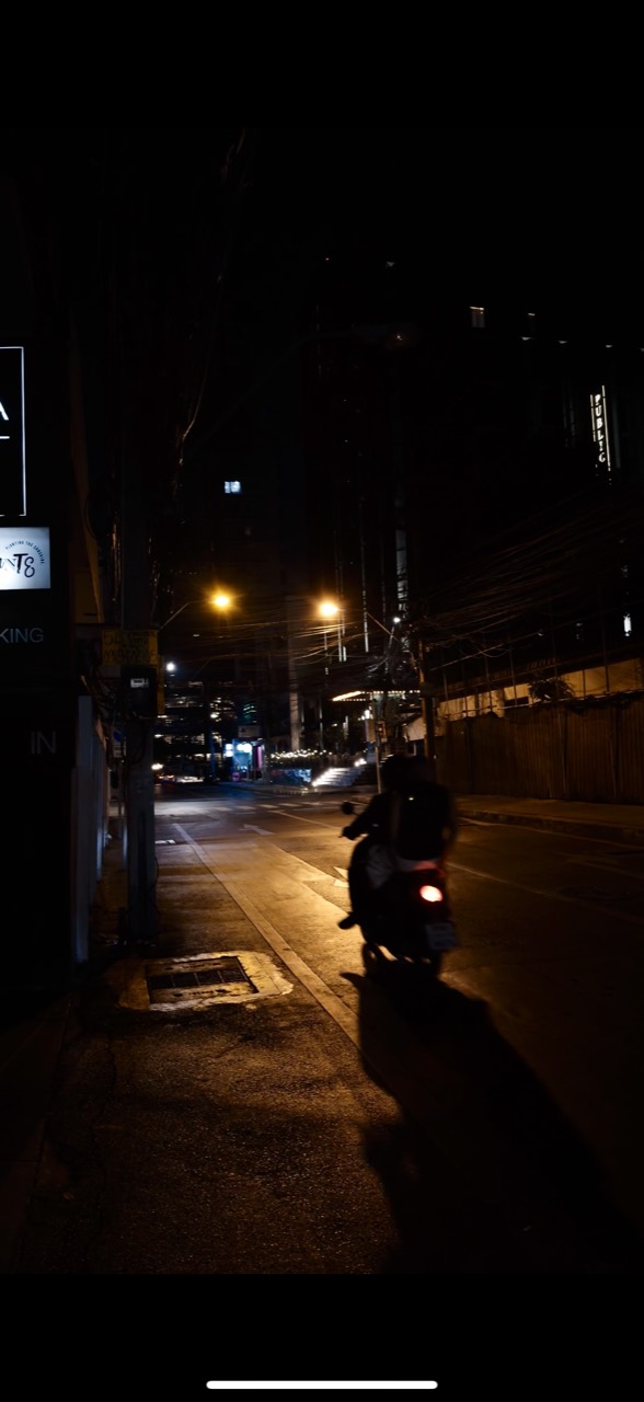 A motorbike on a city street at night