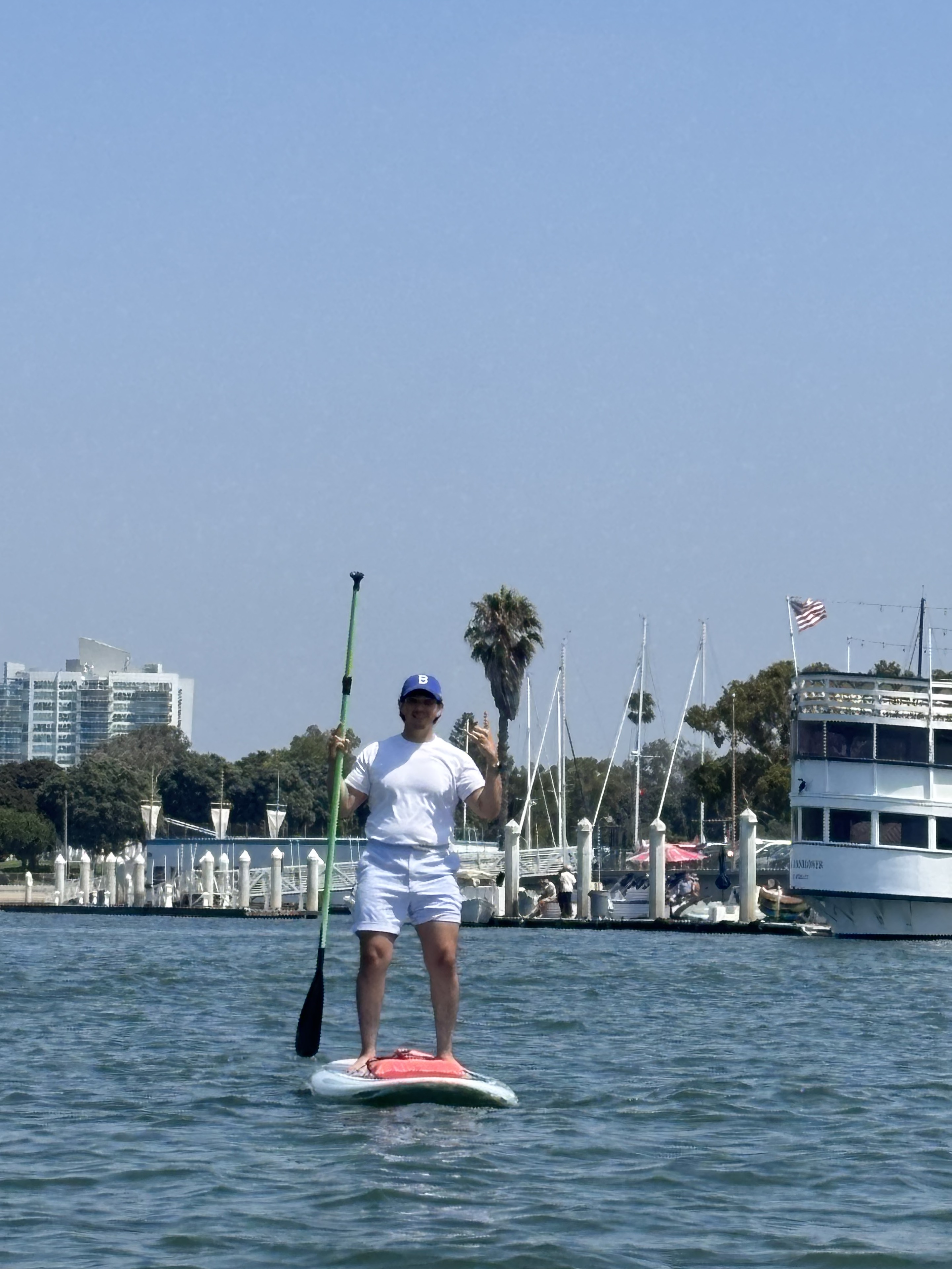Kevin paddleboarding in a marina