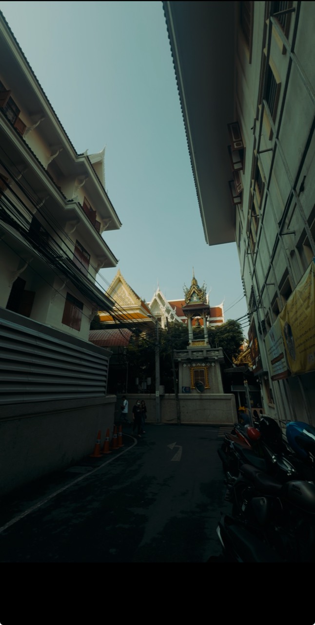 A narrow alley leading toward a temple